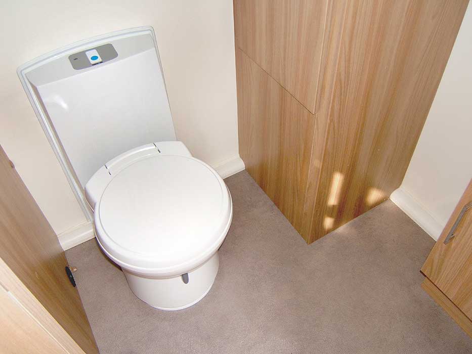 The rear washroom - showing the cassette toilet and storage wardrobe in the corner.